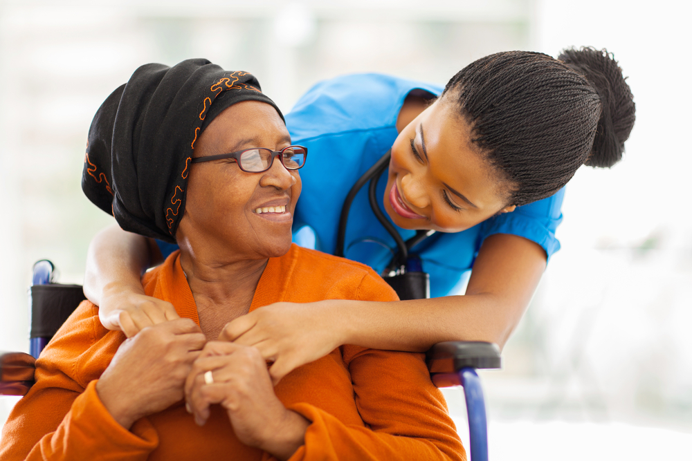 caregiver helping old woman